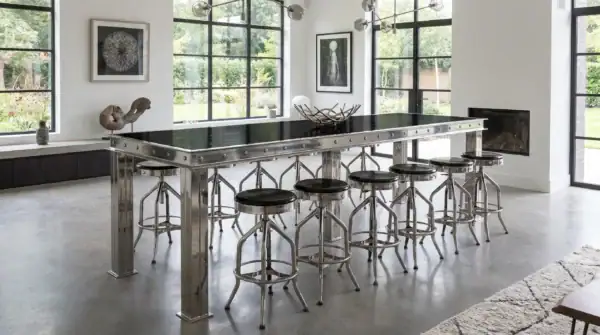 Firehouse bar table in polished stainless with black lacquered oak top — modern luxury home
