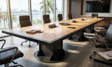 Large I-Beam Pedestal Industrial Boardroom Table with oak top in modern Florida office
