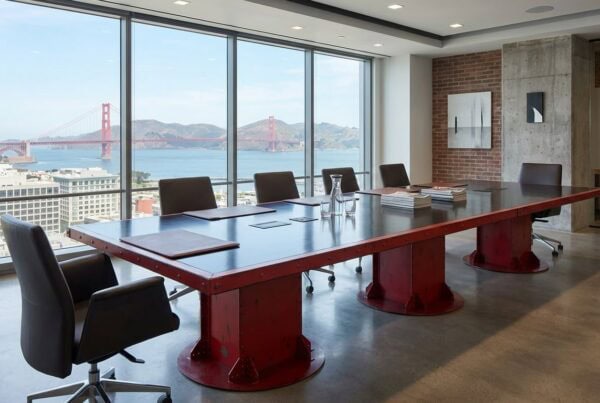 Large red I-Beam Pedestal Industrial Conference Table with black top in San Francisco Executive Boardroom