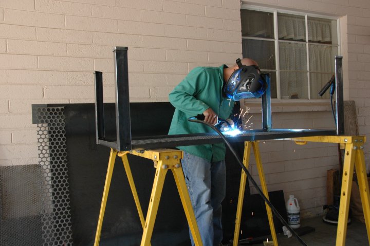 Greg Hankerson welding the first Ellis console in his Phoenix garage, 2009 — the founding of Vintage Industrial